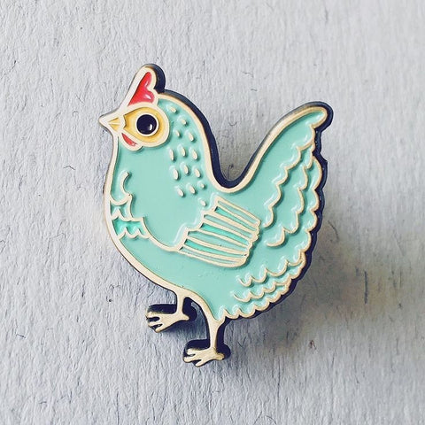This chicken pin is light blue in colour, with big black round eyes. It is very cute.